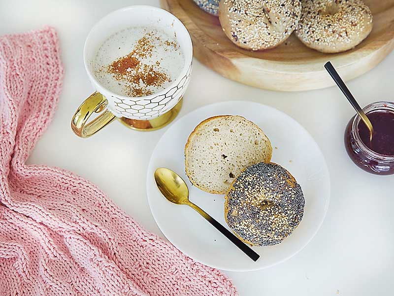 Enjoy these easy & delicious gluten free bagels with your Sunday morning latte! The best part is you absolutely can not tell they are gluten free. I promise! They are free from xanthan gum, guar gum & commercial yeast! These tasty bagels are traditional Canadian Montreal style, slightly sweeter (they are boiled in water sweetened with Canadian maple syrup or honey) and a little smaller smaller than New York style bagels. They are slightly crispy on the outside and chewy on the inside. These gluten free bakes are incredibly tasty with the perfect chewiness you've come to expect from a high quality bagel! If you're gluten free, dairy free, or vegan and miss eating bagels, you're going to love this recipe! Sourdough bagel recipe, gluten free sourdough bagels, gluten free vegan sourdough bagels, gluten free vegan, gluten free bagel recipe, gluten free bagels