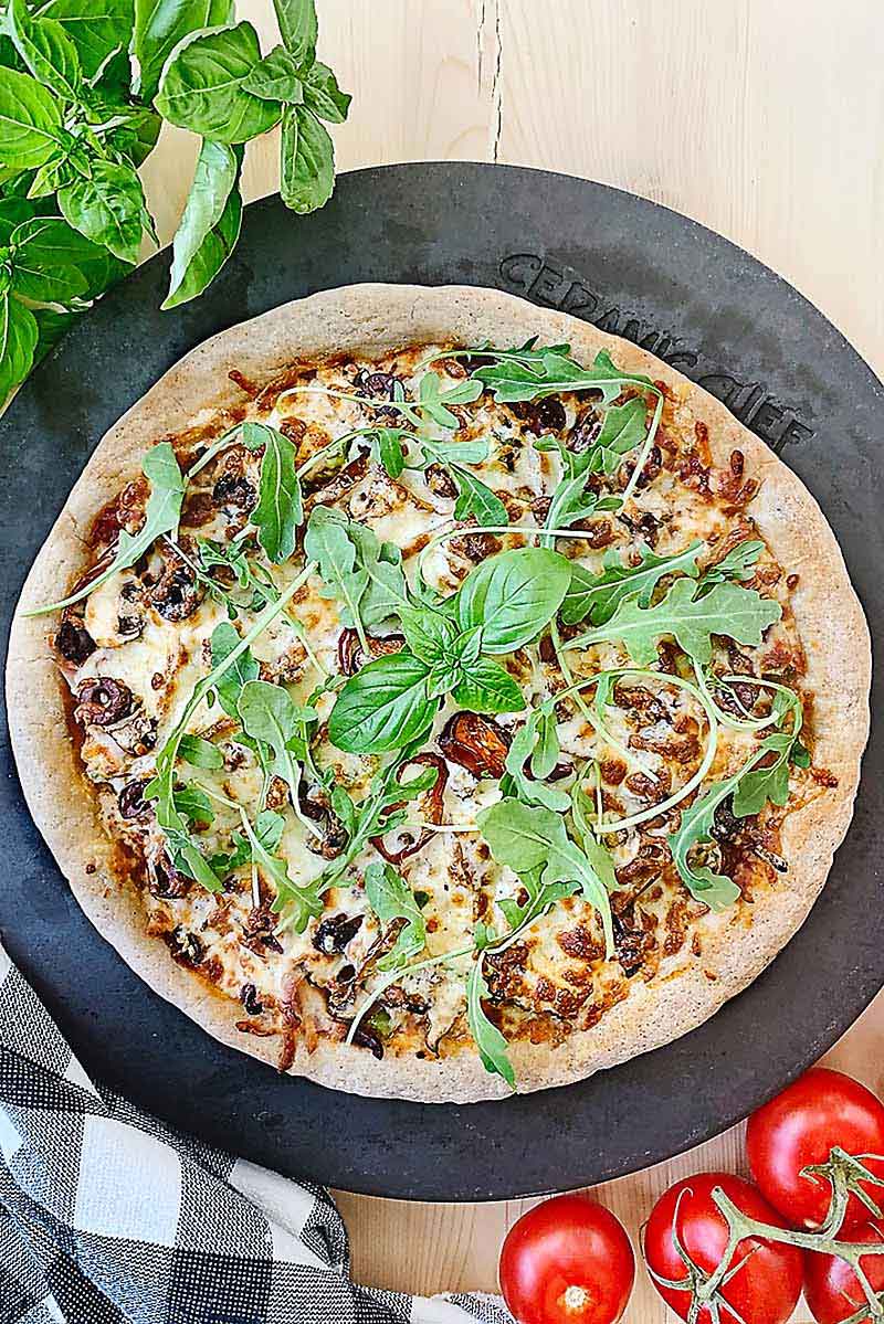 This delightfully delicious Gluten Free Sourdough Pizza is totally customizable for you so that hopefully no matter what your dietary needs are you can find a way to eat pizza again! This easy gluten free sourdough pizza crust is just perfect for Friday night pizza night! Or who are we kidding, pizza night any night really! If you miss having pizza now that you've gone gluten free, you'll love this new addition to our sourdough recipes!