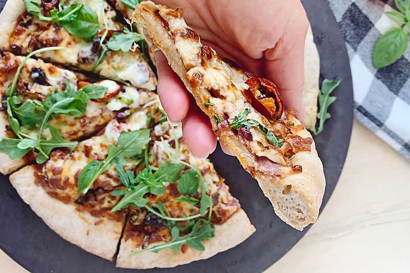 This delightfully delicious Gluten Free Sourdough Pizza is totally customizable for you so that hopefully no matter what your dietary needs are you can find a way to eat pizza again! This easy gluten free sourdough pizza crust is just perfect for Friday night pizza night! Or who are we kidding, pizza night any night really! If you miss having pizza now that you've gone gluten free, you'll love this new addition to our sourdough recipes! Gluten Free Pizza, gluten free pizza crust, allergen friendly pizza crust