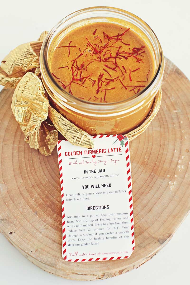 This incredibly delicious healing honey is full of powerful healing spices to give your body the extra boost it needs. Use this honey in warmed milk to make a delicious, healing golden turmeric latte, or even eat it straight off the spoon! Make this healing honey in a jar for the perfect DIY Hostess Gift this holiday season! This healing honey is sure to boost your energy, help you fight off cold & flu season & delight your taste buds at the same time! Turmeric Latte, turmeric steamed milk, golden latte recipe, easy turmeric latte, healing latte, evening latte, pick me up, caffeine free healing latte, immunity boosting recipes, Christmas gift idea, mason jar gift