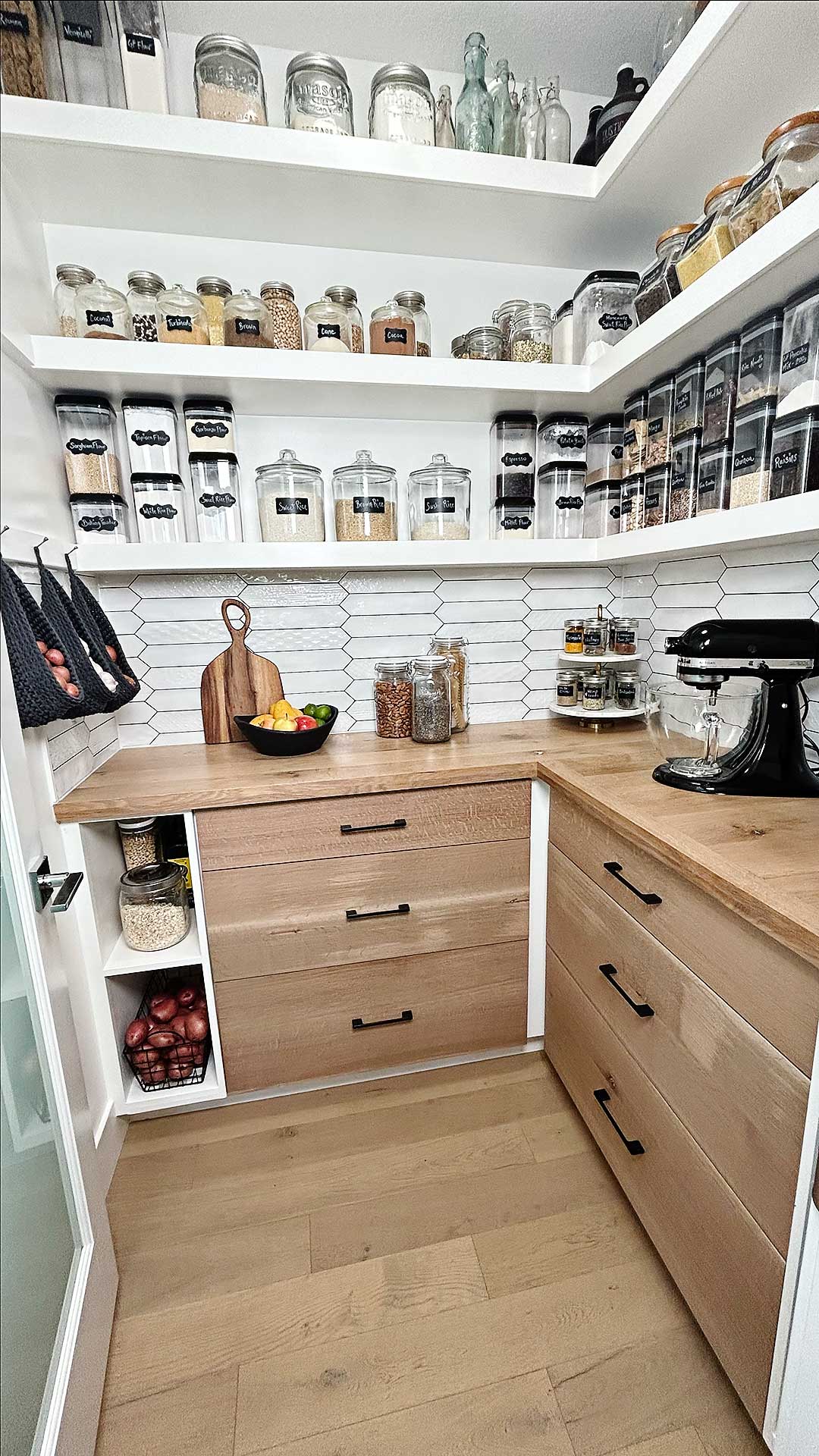 This timeless pantry with gorgeous floating shelves and a wood countertop is made even more functional with gorgeous crochet hanging baskets for simple and beautiful pantry organization. This pantry idea is both stunning and functional! #pantryidea, pantry organization, pantry idea, crochet patterns, free crochet pattern, crochet hanging basket, pantry idea, pantry design, floating shelves, how to build floating shelves, shelves, DIY shelves, wall shelves
