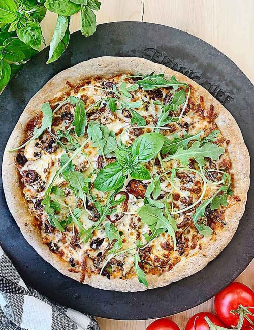 This delightfully delicious Gluten Free Sourdough Pizza is totally customizable for you so that hopefully no matter what your dietary needs are you can find a way to eat pizza again! This easy gluten free sourdough pizza crust is just perfect for Friday night pizza night! Or who are we kidding, pizza night any night really! If you miss having pizza now that you've gone gluten free, you'll love this new addition to our sourdough recipes!