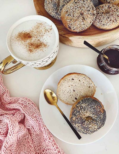 Enjoy these easy & delicious gluten free bagels with your Sunday morning latte! The best part is you absolutely can not tell they are gluten free. I promise! They are free from xanthan gum, guar gum & commercial yeast! These tasty bagels are traditional Canadian Montreal style, slightly sweeter (they are boiled in water sweetened with Canadian maple syrup or honey) and a little smaller smaller than New York style bagels. They are slightly crispy on the outside and chewy on the inside. These gluten free bakes are incredibly tasty with the perfect chewiness you've come to expect from a high quality bagel! If you're gluten free, dairy free, or vegan and miss eating bagels, you're going to love this recipe! Sourdough bagel recipe, gluten free sourdough bagels, gluten free vegan sourdough bagels, gluten free vegan, gluten free bagel recipe, gluten free bagels